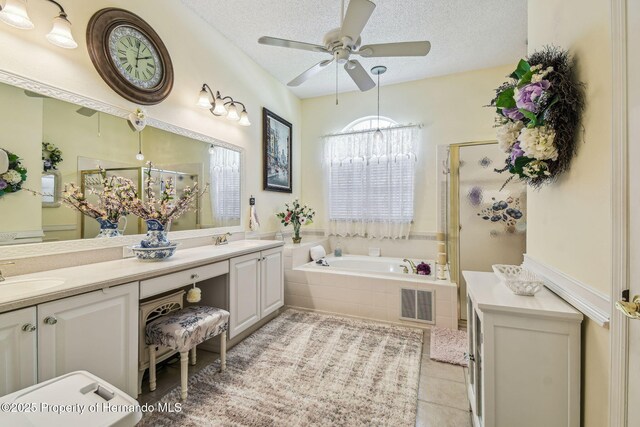 18223 Nestlebranch Ct, Hudson, FL 34667 - full bathroom with a shower stall, a bath, double vanity, tile patterned flooring, and a textured ceiling