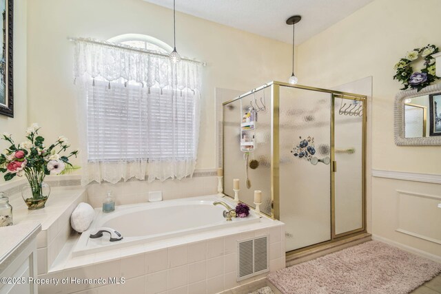 18223 Nestlebranch Ct, Hudson, FL 34667 - bathroom featuring a shower stall, a garden tub, and vanity