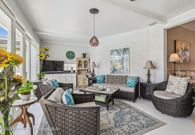 18223 Nestlebranch Ct, Hudson, FL 34667 - carpeted living room with beamed ceiling