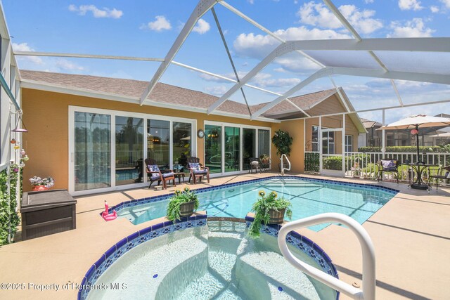 18223 Nestlebranch Ct, Hudson, FL 34667 - view of swimming pool featuring a patio area, a pool with connected hot tub, and a lanai