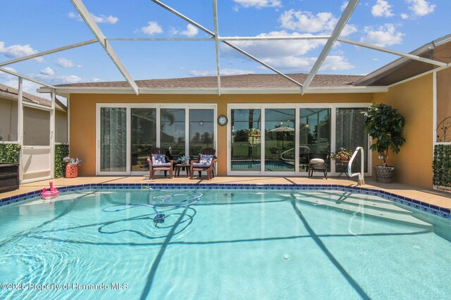 18223 Nestlebranch Ct, Hudson, FL 34667 - outdoor pool featuring a lanai and a patio