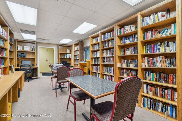 18223 Nestlebranch Ct, Hudson, FL 34667 - office featuring bookshelves, carpet floors, and a paneled ceiling