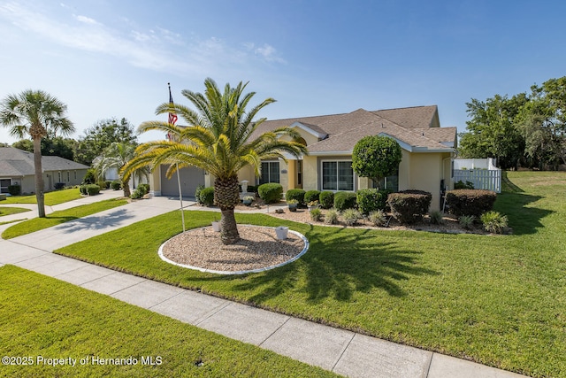 1049 Larkin Rd, Spring Hill, FL 34608 - view of front of home with driveway, an attached garage, stucco siding, and a front lawn