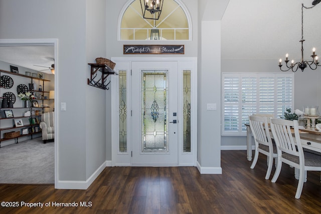 1049 Larkin Rd, Spring Hill, FL 34608 - entrance foyer with a chandelier, baseboards, and dark wood finished floors