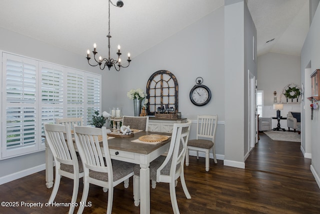1049 Larkin Rd, Spring Hill, FL 34608 - dining space featuring a chandelier, wood finished floors, baseboards, and high vaulted ceiling