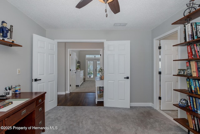 1049 Larkin Rd, Spring Hill, FL 34608 - home office featuring dark carpet, ceiling fan, french doors, a textured ceiling, and baseboards