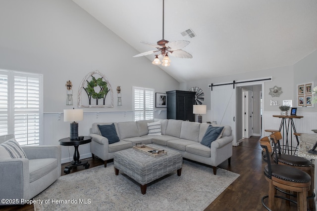 1049 Larkin Rd, Spring Hill, FL 34608 - living area featuring a barn door, high vaulted ceiling, wainscoting, ceiling fan, and dark wood-type flooring