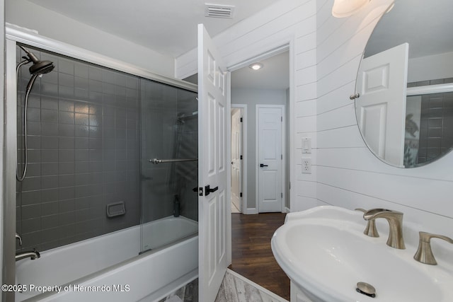 1049 Larkin Rd, Spring Hill, FL 34608 - bathroom with a sink, bath / shower combo with glass door, and wood finished floors