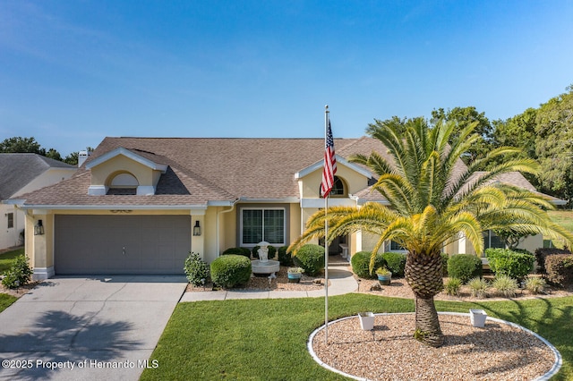 1049 Larkin Rd, Spring Hill, FL 34608 - view of front of home with stucco siding, a garage, concrete driveway, roof with shingles, and a front yard