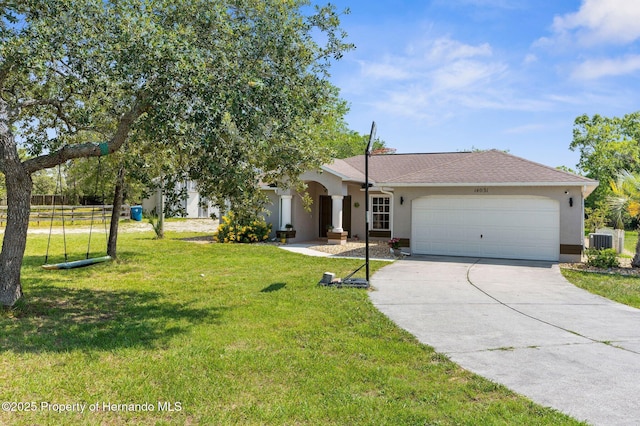 14031 Hexam Rd, Brooksville, FL 34613 - view of front facade with stucco siding, driveway, central AC, and an attached garage