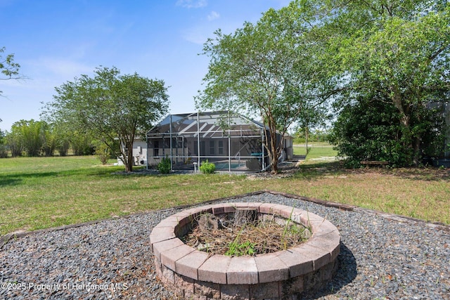 14031 Hexam Rd, Brooksville, FL 34613 - view of green lawn featuring an outdoor fire pit, glass enclosure, and an outdoor pool