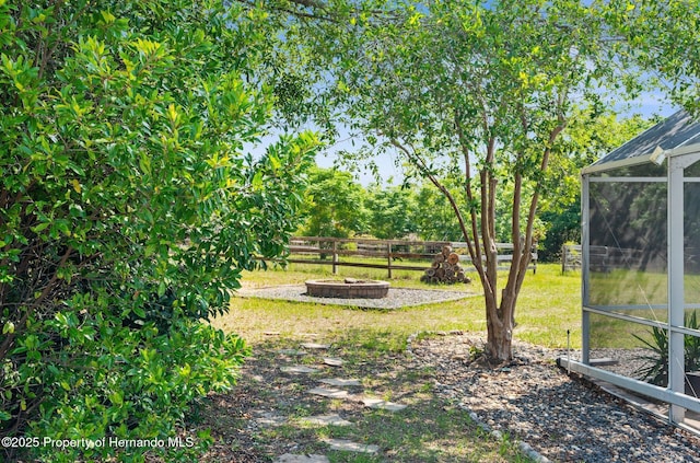 14031 Hexam Rd, Brooksville, FL 34613 - view of yard with a fire pit and glass enclosure