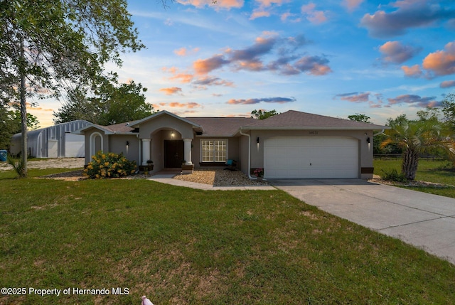 14031 Hexam Rd, Brooksville, FL 34613 - ranch-style house featuring stucco siding, an attached garage, driveway, and a front yard
