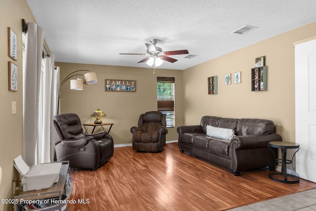 14031 Hexam Rd, Brooksville, FL 34613 - living area featuring ceiling fan, wood finished floors, a textured ceiling, and baseboards
