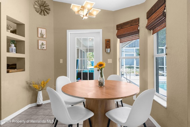 14031 Hexam Rd, Brooksville, FL 34613 - dining space featuring a chandelier, baseboards, and light tile patterned floors