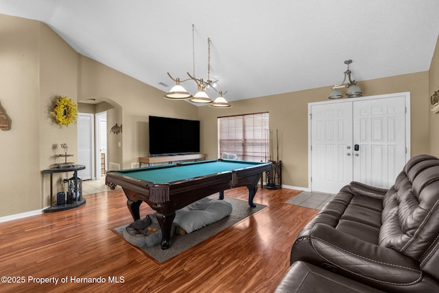 14031 Hexam Rd, Brooksville, FL 34613 - recreation room featuring vaulted ceiling, arched walkways, billiards, baseboards, and wood finished floors