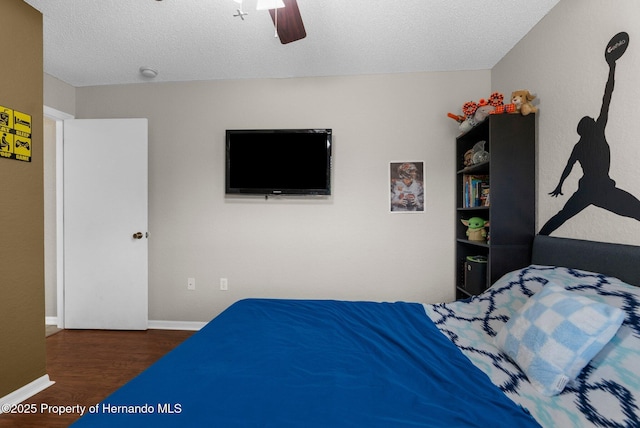 14031 Hexam Rd, Brooksville, FL 34613 - bedroom with wood finished floors, ceiling fan, baseboards, and a textured ceiling
