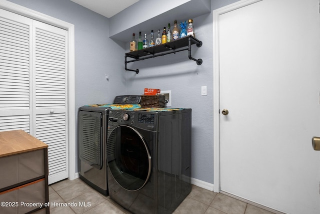 14031 Hexam Rd, Brooksville, FL 34613 - washroom with washing machine and dryer, light tile patterned floors, and baseboards