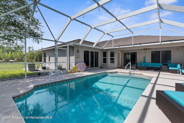 14031 Hexam Rd, Brooksville, FL 34613 - outdoor pool featuring outdoor lounge area, a patio area, ceiling fan, and glass enclosure