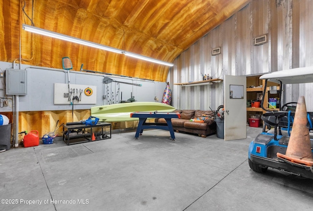 14031 Hexam Rd, Brooksville, FL 34613 - garage featuring wood walls and electric panel