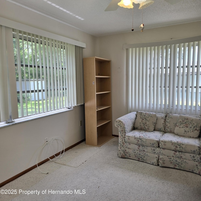 2226 Giralda Ave, Spring Hill, FL 34606 - living room featuring a ceiling fan and baseboards