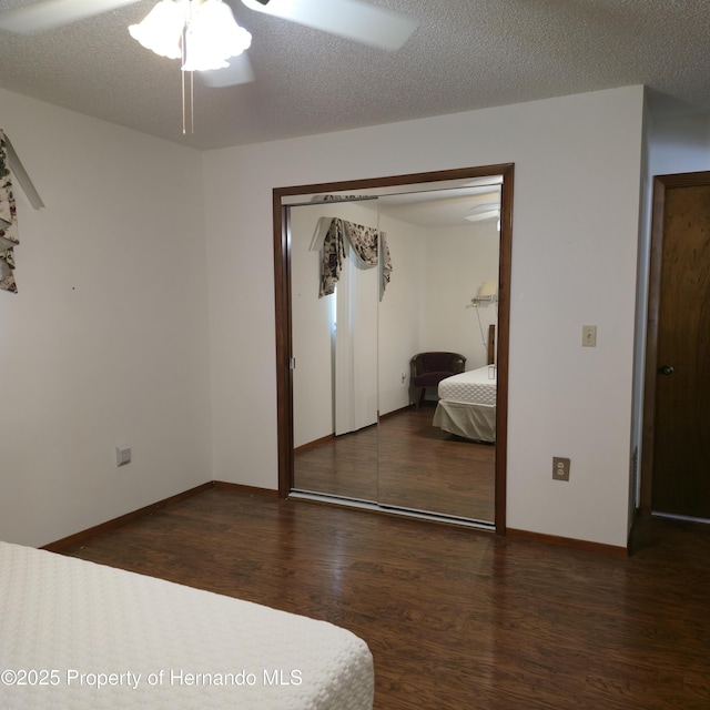 2226 Giralda Ave, Spring Hill, FL 34606 - unfurnished bedroom featuring wood finished floors, a closet, baseboards, and ceiling fan