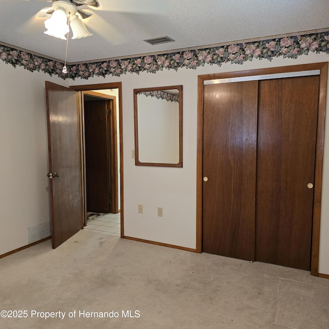 2226 Giralda Ave, Spring Hill, FL 34606 - unfurnished bedroom with light colored carpet, baseboards, a closet, and a ceiling fan