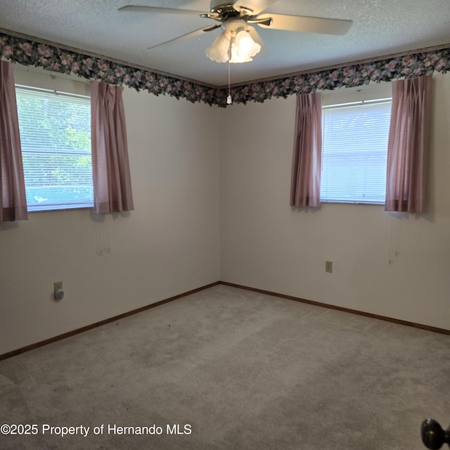 2226 Giralda Ave, Spring Hill, FL 34606 - empty room featuring light colored carpet, a ceiling fan, a textured ceiling, and baseboards