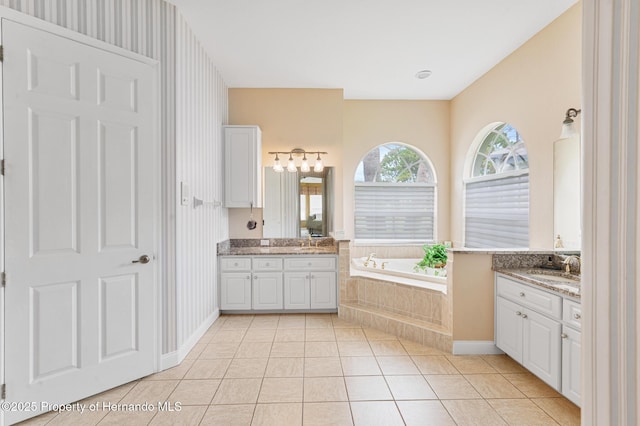 5182 Championship Cup Ln, Spring Hill, FL 34609 - full bath with two vanities, a bath, tile patterned floors, baseboards, and wallpapered walls