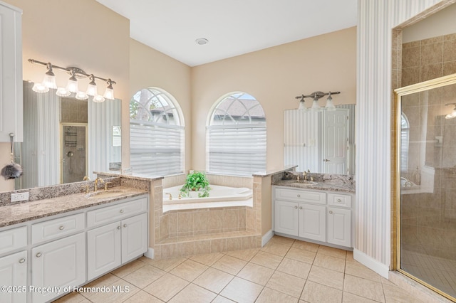 5182 Championship Cup Ln, Spring Hill, FL 34609 - full bath with two vanities, a stall shower, and a bath
