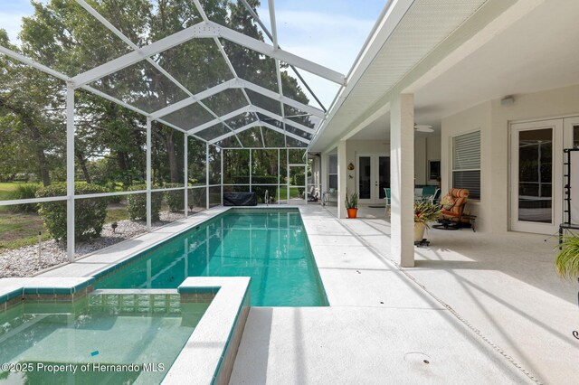 5182 Championship Cup Ln, Spring Hill, FL 34609 - outdoor pool with french doors, a patio area, ceiling fan, and a lanai