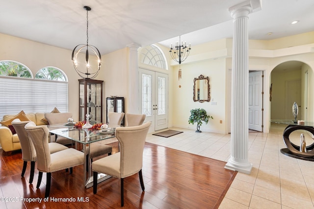 5182 Championship Cup Ln, Spring Hill, FL 34609 - dining area featuring arched walkways, decorative columns, plenty of natural light, light tile patterned flooring, and recessed lighting