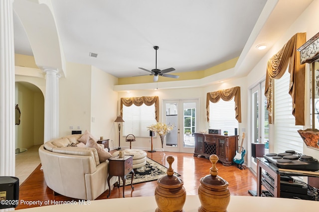 5182 Championship Cup Ln, Spring Hill, FL 34609 - living room with ceiling fan, decorative columns, arched walkways, and wood finished floors
