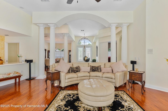 5182 Championship Cup Ln, Spring Hill, FL 34609 - living area with ornate columns, wood finished floors, a ceiling fan, baseboards, and arched walkways
