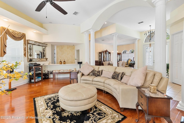 5182 Championship Cup Ln, Spring Hill, FL 34609 - living area with decorative columns, ceiling fan, healthy amount of natural light, and wood finished floors