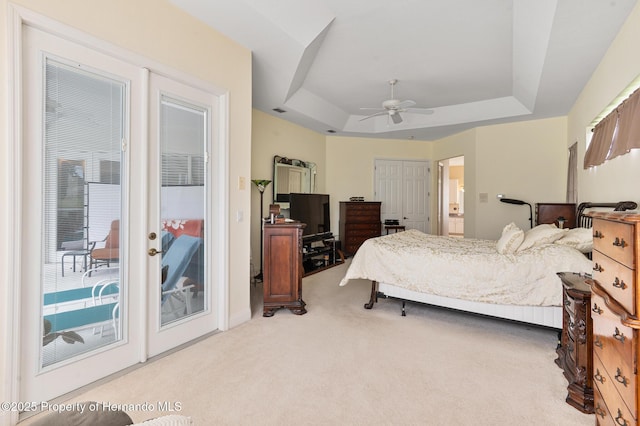 5182 Championship Cup Ln, Spring Hill, FL 34609 - bedroom with a tray ceiling, access to exterior, carpet floors, a ceiling fan, and french doors