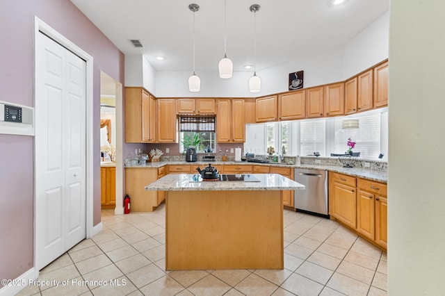 5182 Championship Cup Ln, Spring Hill, FL 34609 - kitchen with stainless steel dishwasher, a kitchen island, black electric cooktop, light stone counters, and light tile patterned floors