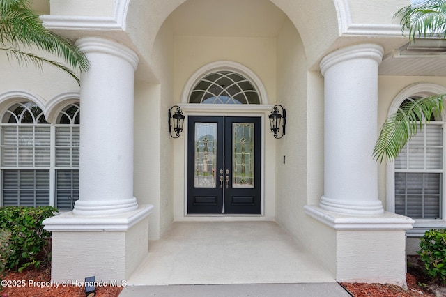5182 Championship Cup Ln, Spring Hill, FL 34609 - property entrance featuring french doors and stucco siding