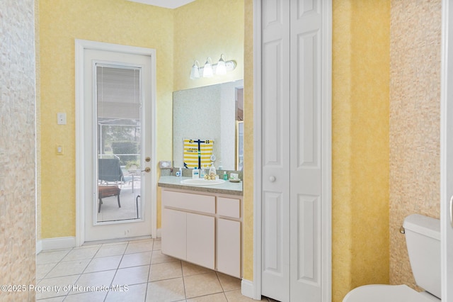 5182 Championship Cup Ln, Spring Hill, FL 34609 - bathroom featuring a closet, vanity, toilet, tile patterned flooring, and baseboards