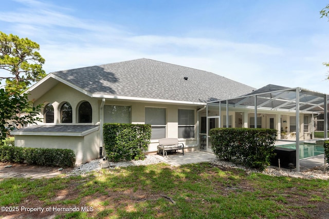 5182 Championship Cup Ln, Spring Hill, FL 34609 - back of house featuring roof with shingles, stucco siding, a patio area, and an outdoor pool