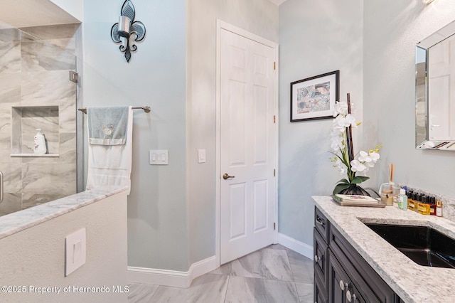 5182 Championship Cup Ln, Spring Hill, FL 34609 - bathroom featuring vanity, baseboards, tiled shower, and marble finish floors