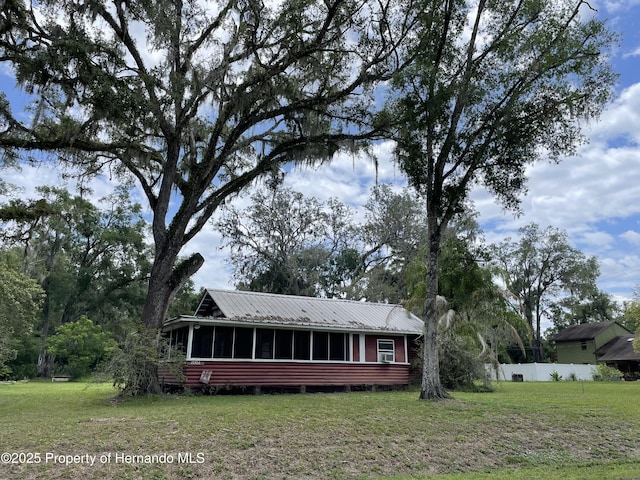 15306 Spokane Rd, Spring Hill Pasco, FL 34610 - view of front facade featuring a sunroom and metal roof