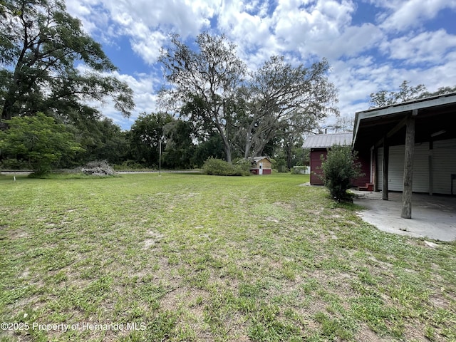 15306 Spokane Rd, Spring Hill Pasco, FL 34610 - view of grassy yard featuring an outdoor structure