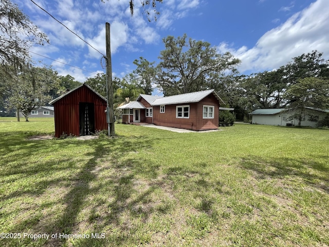 15306 Spokane Rd, Spring Hill Pasco, FL 34610 - view of green lawn with an outbuilding