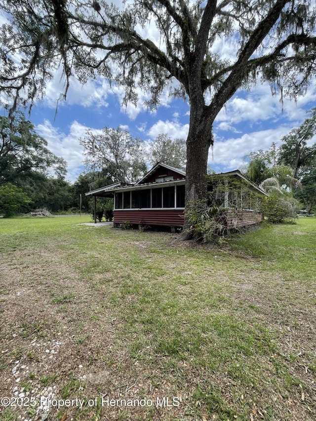 15306 Spokane Rd, Spring Hill Pasco, FL 34610 - back of property with a sunroom and a yard