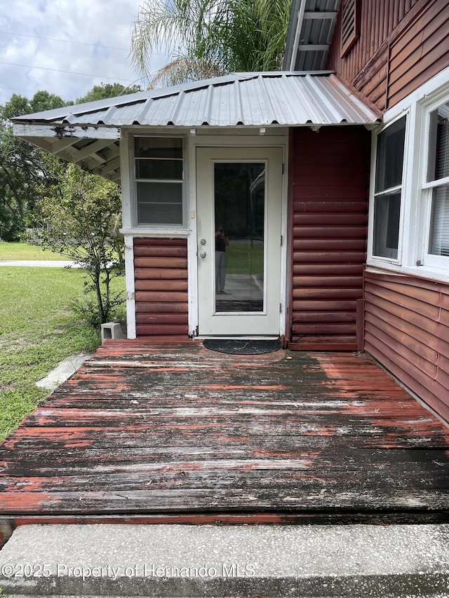 15306 Spokane Rd, Spring Hill Pasco, FL 34610 - entrance to property featuring metal roof, a yard, and a wooden deck