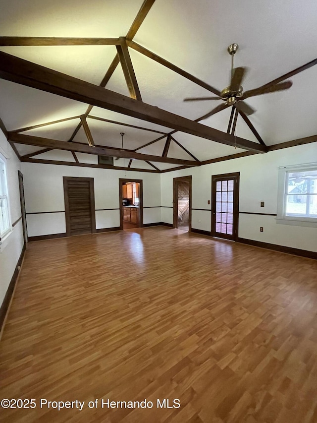 15306 Spokane Rd, Spring Hill Pasco, FL 34610 - unfurnished living room with baseboards, ceiling fan, wood finished floors, beam ceiling, and high vaulted ceiling