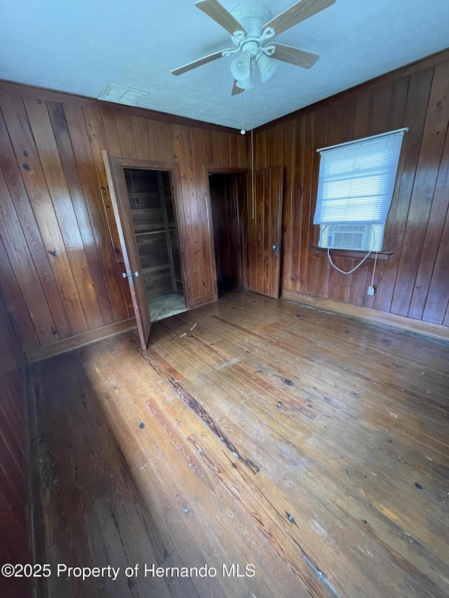 15306 Spokane Rd, Spring Hill Pasco, FL 34610 - unfurnished bedroom with hardwood / wood-style flooring, cooling unit, and wood walls