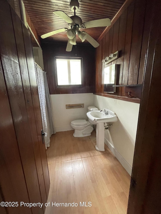 15306 Spokane Rd, Spring Hill Pasco, FL 34610 - bathroom with toilet, wood finished floors, a ceiling fan, and baseboards