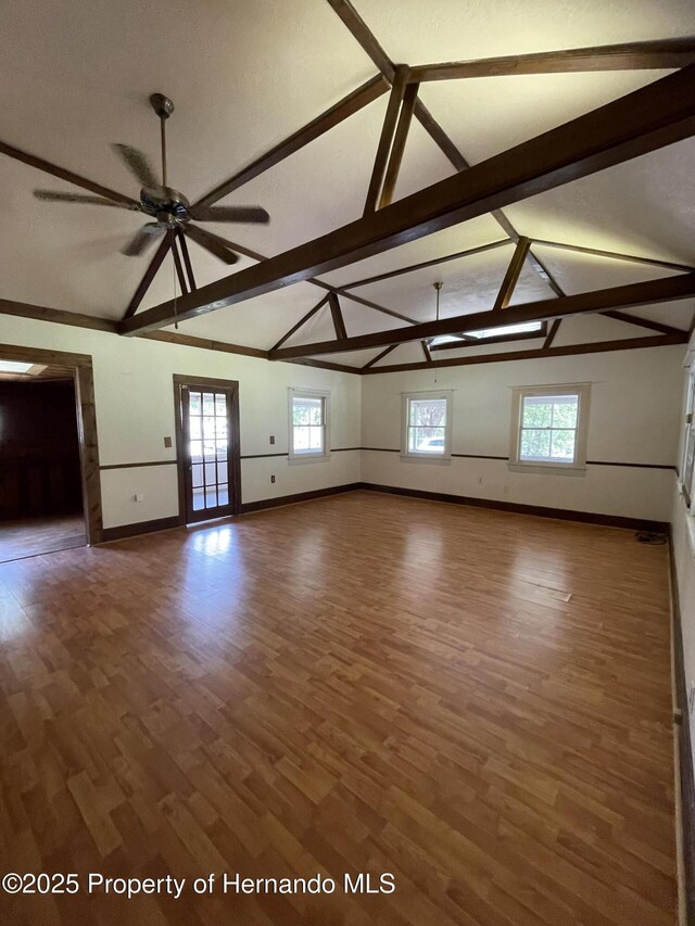 15306 Spokane Rd, Spring Hill Pasco, FL 34610 - unfurnished living room featuring baseboards, ceiling fan, and wood finished floors